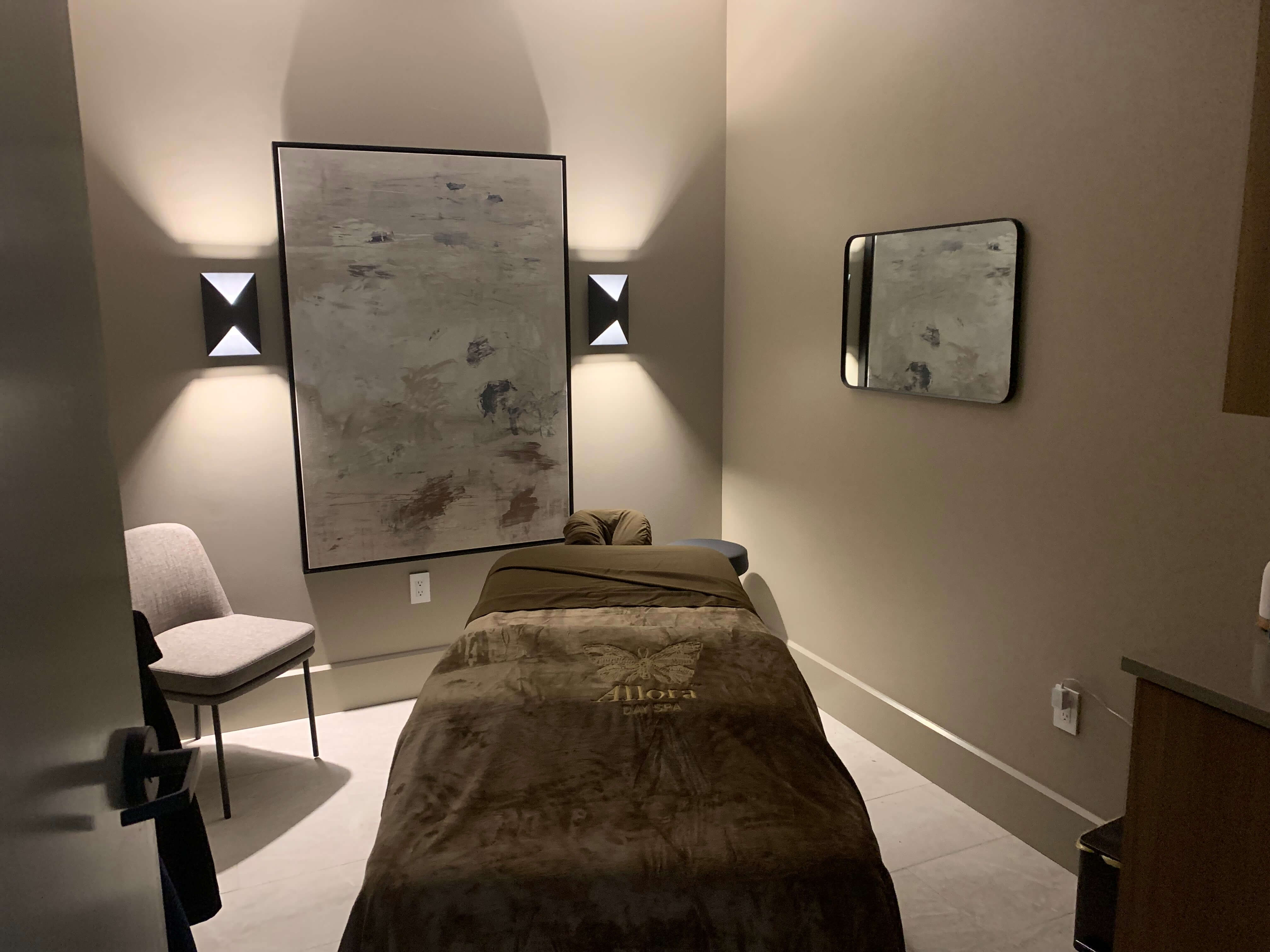 A modern, softly lit bedroom with a single bed.