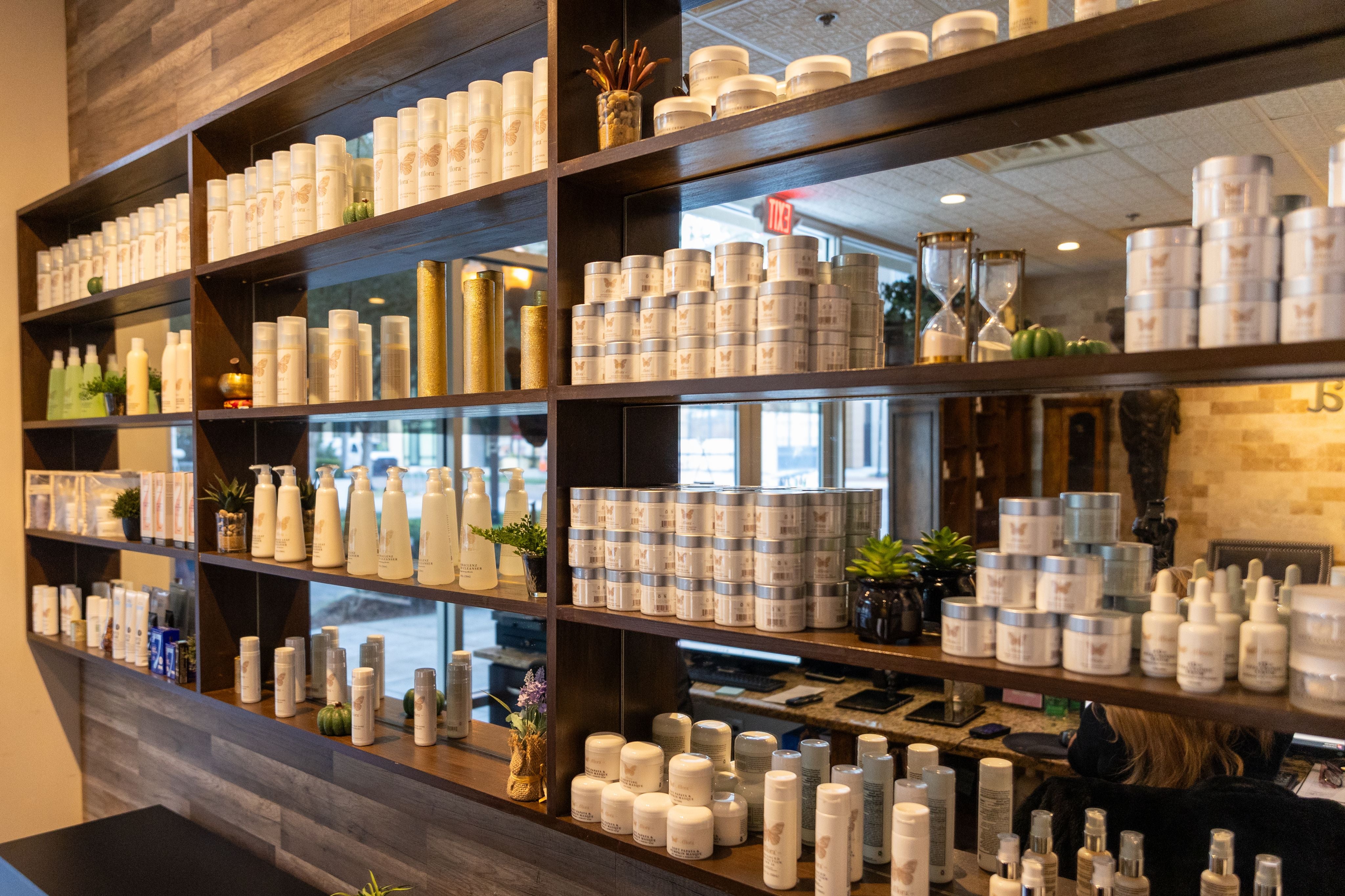 Allora spa retail area displaying shelves filled with skincare products.