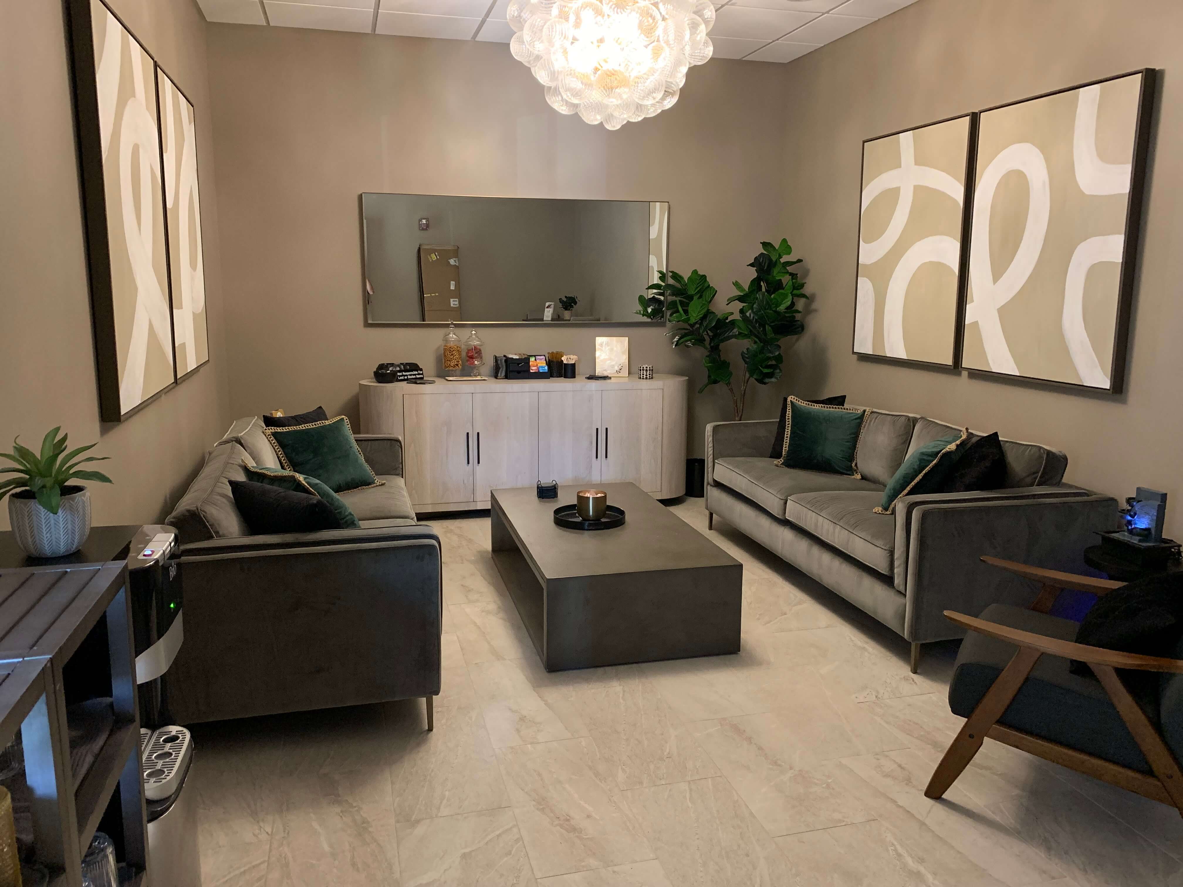 Luxury spa lounge with two gray sofas, a coffee table